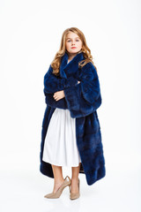 Fototapeta premium Girl in mother's fur coat, long dress, women classic shoes