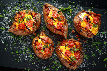 hot baked sweet potato stuffed with bacon, cheddar cheese, cherry tomatoes, balsamic vinegar, cress...