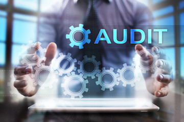 Businessman using tablet pc and selecting audit.