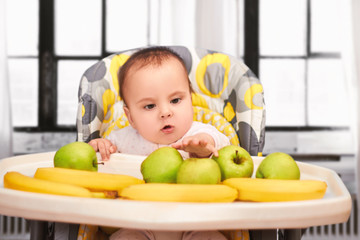 funny baby girl sitting in Chair for babies