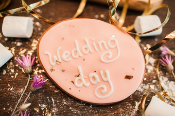 Wedding day background. Sweets for decoration. Handmade wedding cookie decorated with lettering on...
