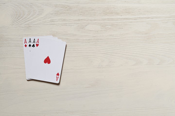 four aces. on a light wooden table. Playing cards, casino. Risk and luck abstraction. Free space for your text.