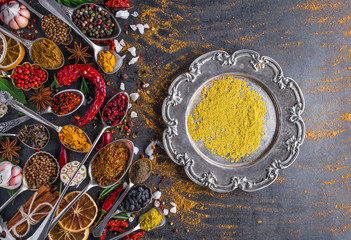 Various spices spoons on stone table. Top view .