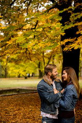 Smiling couple hugging in autumn park