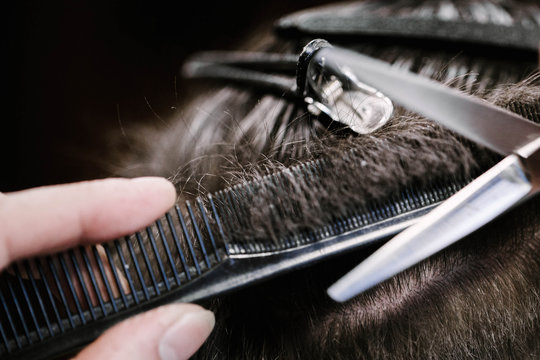 Barber holds hair on the brush