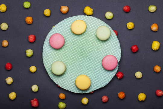 colorful tasty dragee sweets and round green wafer or waffle