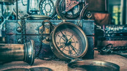 Antique compass and wooden treasure chest.