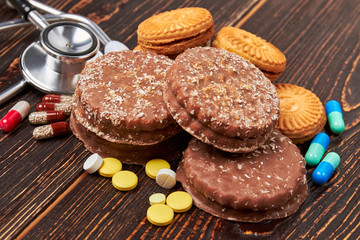 Stethoscope, cookies and pills. Control your sugar level.