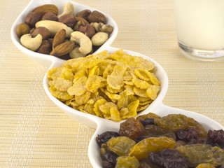 a glass of milk with dried fruits and flakes. 