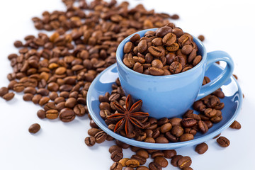 Cup of coffee and beans with delicious macaroon on a white background.
