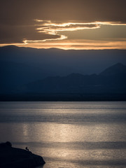Silhoutte of fisherman in golden sunset, Dique de Ullum, San Juan Argentina