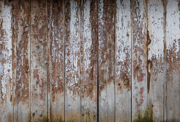 Fototapeta na wymiar Peeling paint on a wooden wall