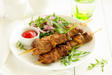 Beef shish kebab  on skewers in curry.