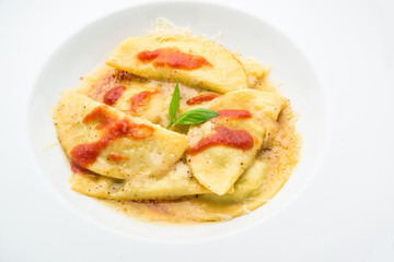 Obraz na płótnie Canvas Ravioli with tomato sauce and basil