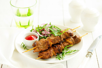 Beef shish kebab  on skewers in curry.
