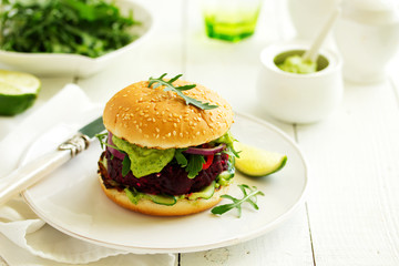 Vegetarian vegetable burger with beetroot and guacamole sauce.