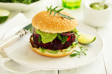 Vegetarian vegetable burger with beetroot and guacamole sauce.