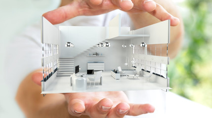 Businessman holding white 3D rendering apartment in his hand