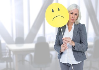 Sad businesswoman against bright office