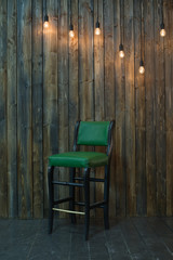 green chair and wood wall