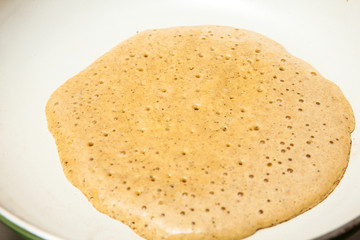 Quinoa crepes preparation : Cooking the quinoa crepes batter onto a frying pan