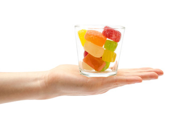 woman hand holding glass with candy