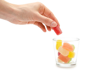 woman hand holding glass with candy.