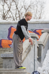 Parkour in park - blonde guy teenager ready for acrobatic jump - flip