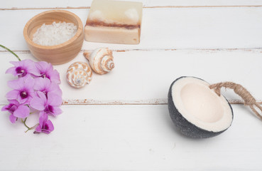 Aromatherapy  product  Spa set ,candle ,soap,coconut orchid flower,shell,  massage  with white wood  background . top view composition.