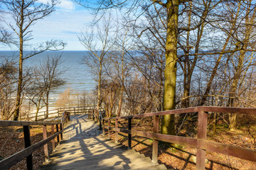 Fototapeta premium Wooden stairs into the sandy beach in Jastrzebia Gora. Baltic Sea in spring time. Poland. 