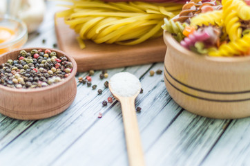 Fototapeta premium Still life with pasta ingredients on the wooden background