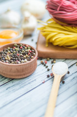 Still life with pasta ingredients on the wooden background