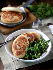 Potato cakes with cheese, yogurt sauce and lettuce leaf. 
