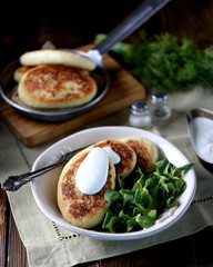 Potato cakes with cheese, yogurt sauce and lettuce leaf. 