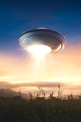 UFO with abduction beam flying in the sky © fergregory