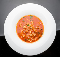 tomato soup with pasta on the plate