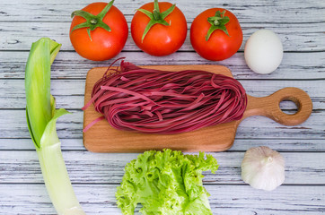 Still life with pasta ingredients on the wooden background