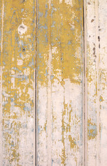 Texture of old beige boards with flaking gold paint