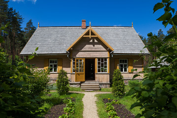 Fototapeta na wymiar Wooden rural house and green garden, Baltic traditions, Latvia