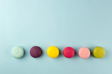 Colourful french macaroons on the blue background, Top view