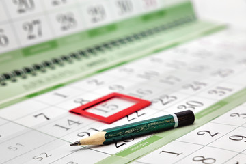 Pencil on the calendar with a bookmark on the date. Business Details