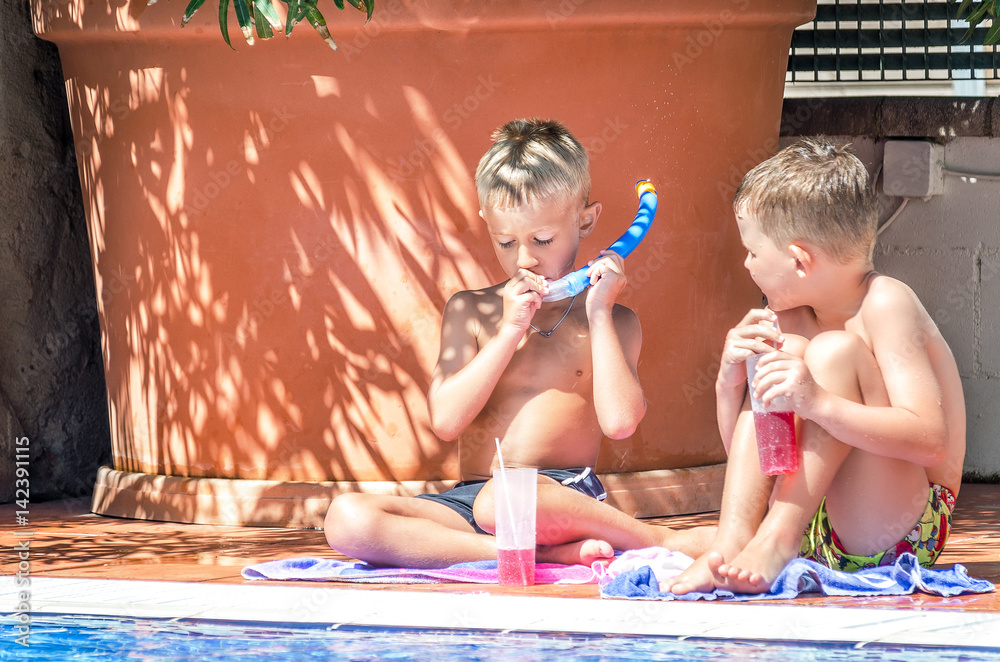 Wall mural Children playing by the pool