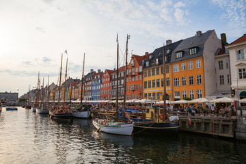 COPENHAGEN, DENMARK - 26 JUNE, 2016: People are relaxing in small canal with colorful houses and boats