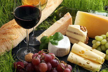 Cheese platter and wine with different cheese and grapes