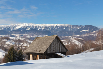 Fototapeta na wymiar Winter in Transylvania (Romania) Old traditional countryside house in winter