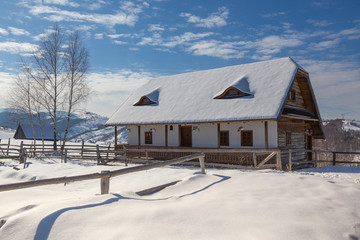 Fototapeta premium Winter in Transylvania (Romania) Old traditional countryside house in winter