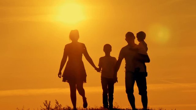 happy family at sunset silhouette of the water