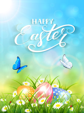 Blue background with butterflies and three Easter eggs in grass