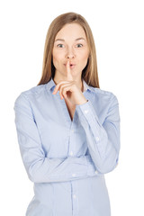 woman showing hand silence sign, asking someone to keep it quiet. human emotion expression and lifestyle concept. image on a white studio background.