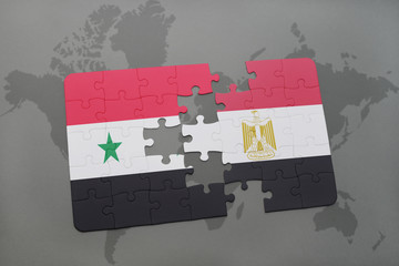 puzzle with the national flag of syria and egypt on a world map